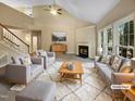 Virtually staged living room with fireplace and large windows at 104 Longbridge Dr, Cary, NC 27518