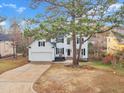 Inviting white two-story home with attached garage and front yard at 110 Modena Dr, Cary, NC 27513