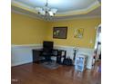 Bright dining room with hardwood floors and a workspace at 1433 Dexter Ridge Dr, Holly Springs, NC 27540