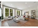 Bright living room with hardwood floors, large windows, and comfy furniture at 1500 Village Hall Ln # 39, Wake Forest, NC 27587