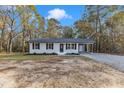 Newly renovated single story home with gray accents and a carport at 1518 Parks Village Rd, Zebulon, NC 27597