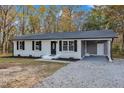 Newly renovated single story home with gray accents and a carport at 1518 Parks Village Rd, Zebulon, NC 27597