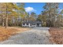 Newly renovated single story home with gray accents and a carport at 1518 Parks Village Rd, Zebulon, NC 27597