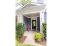 Inviting front porch with red chair and landscaping at 266 Lexes Trl, Chapel Hill, NC 27516