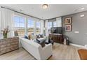 Bright living room with large windows and comfortable seating at 10537 Pleasant Branch Dr # 101, Raleigh, NC 27614