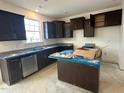 Modern kitchen with dark cabinets and an island at 1105 Channel Drop Lp, Zebulon, NC 27597