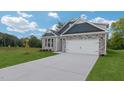 Charming house with stone and blue siding, two-car garage, and a spacious driveway at 1680 Abberly Pl, Graham, NC 27253