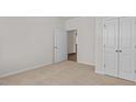 Well-lit bedroom with plush carpeting and double door closet at 2523 Trevana Way, Graham, NC 27253