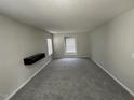 Spacious bedroom with gray carpeting and a wall-mounted shelf at 305 Pebblestone Dr, Durham, NC 27703