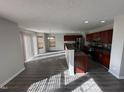 Kitchen with dark wood cabinets, granite countertops, and stainless steel appliances at 305 Pebblestone Dr, Durham, NC 27703