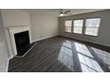 Living room featuring hardwood floors, fireplace, and large windows at 305 Pebblestone Dr, Durham, NC 27703