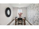 Elegant dining room with hardwood floors, statement wall, and wooden table at 6433 Alfalfa Ln, Wake Forest, NC 27587