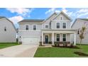 Two-story house with gray siding, stone accents, and a front porch at 280 Umstead St, Sanford, NC 27330