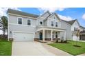 Two-story house with gray siding, stone accents, and a front porch at 280 Umstead St, Sanford, NC 27330