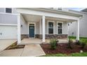 Covered porch with stone base and blue front door at 280 Umstead St, Sanford, NC 27330