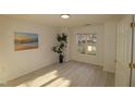 Bright and airy bedroom with a large window and laminate wood flooring at 11331 Involute Pl # 100, Raleigh, NC 27617