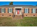 Brick ranch house with red front door and stairs at 1204 Breedlove Rd, Nashville, NC 27856