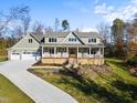 Two-story craftsman style home with a large front porch and three car garage at 154 Leatherwood Ln, Chapel Hill, NC 27517