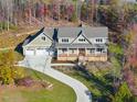Two-story house with a three-car garage and a long driveway at 154 Leatherwood Ln, Chapel Hill, NC 27517