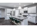 Modern kitchen with white cabinets, granite counters, and an island at 2510 Seacoast Ave, Durham, NC 27703