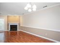 Living room with hardwood floors and a fireplace at 3116 Coachmans Way, Durham, NC 27705