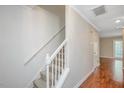 Straight staircase with simple railing and carpeted steps at 3116 Coachmans Way, Durham, NC 27705