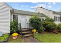 Inviting front entrance with stairs and potted plants at 1146 Rogers Rd, Graham, NC 27253