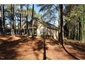 Home nestled amongst trees, showcasing side yard at 318 Rawls Church Rd, Angier, NC 27501