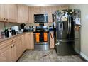 Kitchen with stainless steel appliances and light wood cabinets at 82 Stonecliff Ln, Sanford, NC 27332