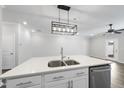 Kitchen island with white cabinets, quartz countertop, and double sink at 1005 Kindness Ln, Durham, NC 27703