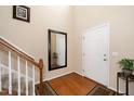 Bright entryway with hardwood floors, staircase, and mirror at 128 Chownings Dr, Sanford, NC 27330