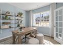 Home office with built-in shelving, large window, and a workspace at 2010 Fletchers Ridge Dr, Durham, NC 27703