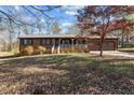 Single story home with wood siding, attached garage, and a spacious front yard at 2942 Woodside Ave, Graham, NC 27253