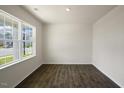 Bright room with large windows and dark hardwood floors at 409 Blue Aspen Dr, Fuquay Varina, NC 27526