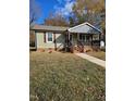 Inviting single-story home with a covered porch and neat landscaping at 409 Granville St, Oxford, NC 27565