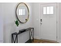 Bright entryway with a large round mirror and console table at 720 Apple Churn Dr, Fuquay Varina, NC 27526