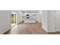 Kitchen with island, stainless steel appliances, and vinyl plank flooring at 7549 Michelle Rd, Rocky Mount, NC 27803