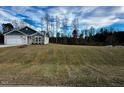 Landscaped yard with new sod in front of a two-story house at 7586 Michelle Rd, Rocky Mount, NC 27803