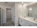 Double vanity, walk-in shower, and access to a large closet at 7622 Michelle Rd, Rocky Mount, NC 27803