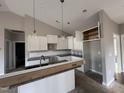 White shaker cabinets, granite countertops, and pendant lighting at 927 Micro W Rd, Selma, NC 27576