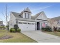 Gray two-story house with white garage door and American flag at 1008 Tuscarora Ln, Durham, NC 27703