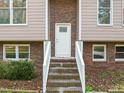 Front entrance with brick steps and white door at 108 N Woodshed Ct, Cary, NC 27513