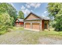 Two-car garage with stone accents and a separate entrance at 3240 Hillcastle Trl, Chapel Hill, NC 27516
