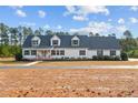 Two-story home with a white exterior, blue shutters, and a spacious yard at 3450 Leaflet Church Rd, Broadway, NC 27505