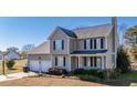 Two-story house with attached two-car garage and landscaped yard at 360 Sandy Ridge Rd, Dunn, NC 28334