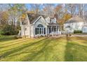 House with a well-manicured lawn and mature trees at 1208 Turnstone Dr, Rocky Mount, NC 27803