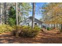 Lakefront home nestled among tall trees in the fall at 148 Silver Lake Pt Pt, Sanford, NC 27332