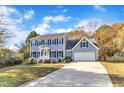 Two-story house with gray siding, a white door, and a two-car garage at 1706 Lisburn Ct, Garner, NC 27529