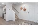 Bright entryway with stairs, wood-look floors, and coat rack at 2547 Lily Dr # 191, Haw River, NC 27258