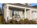 Front porch with rocking chairs and blooming flowers at 2913 Violet Way, Fuquay Varina, NC 27526